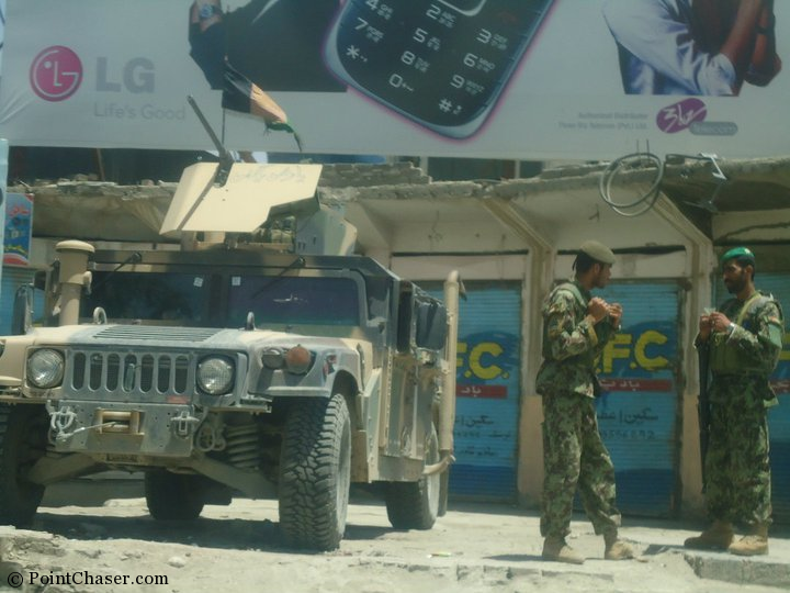 Afghan soldiers chatting near an unmanned tank