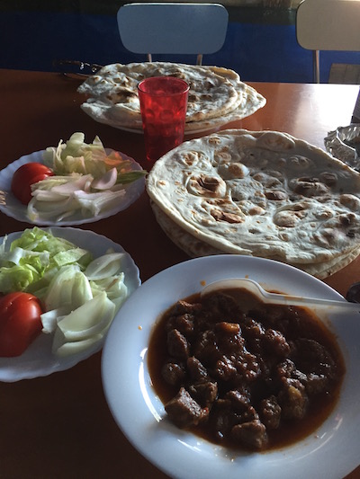 Beef Qorma, salad, and bread at the New Kabul Restaurant in the Calais Jungle